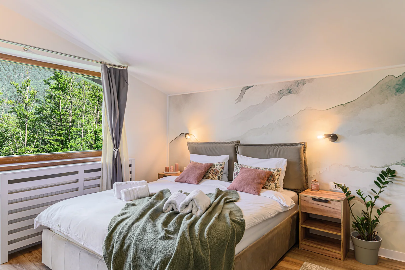Double bed beside the forest-facing window — Studio 4